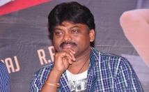 give Director Karunakaran's contact details